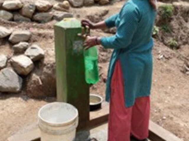 Nepalese woman getting water