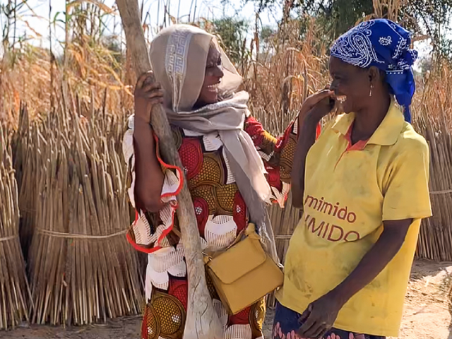 Two women chatting a grain field