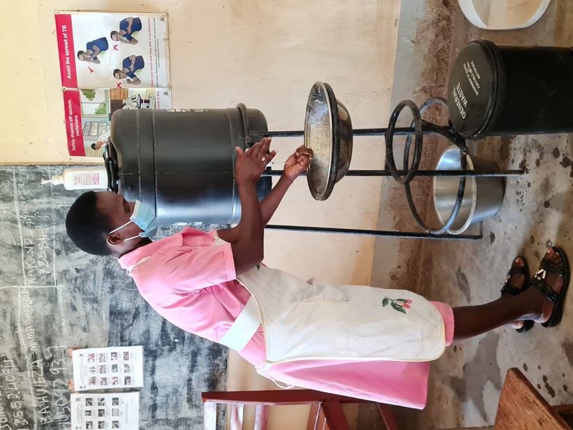 A nurse washing in hands in a healthcare facility in Kabarole, Uganda