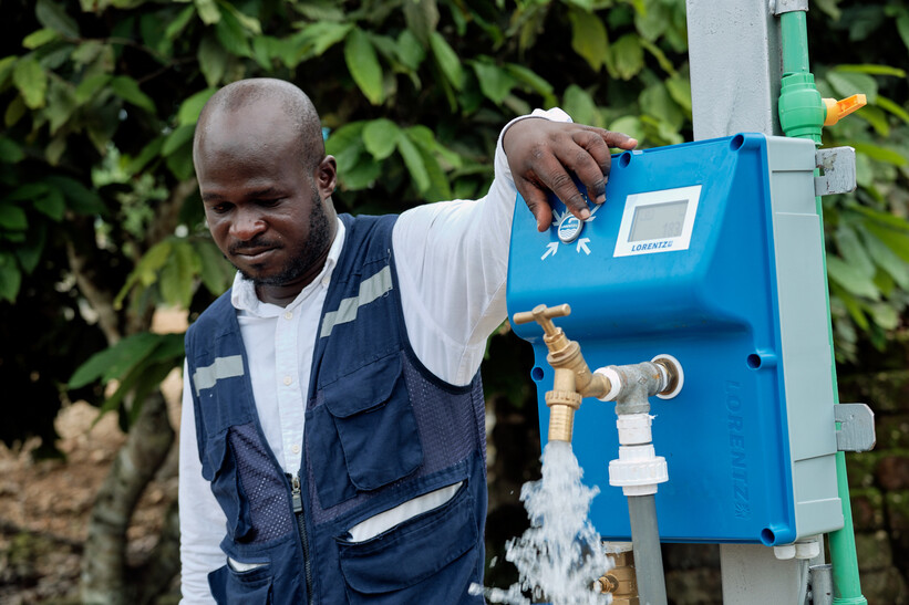 Staff member of CWSA in Ghana adjusting the water flow
