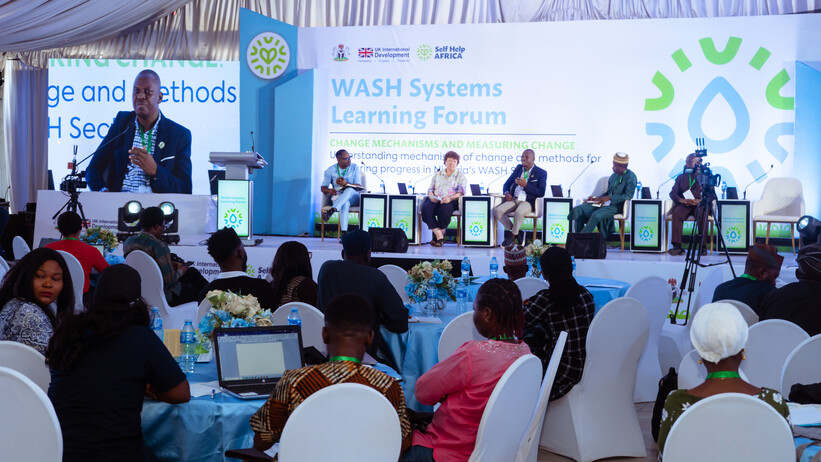 People on stage at the WASH Systems Learning Forum Nigeria