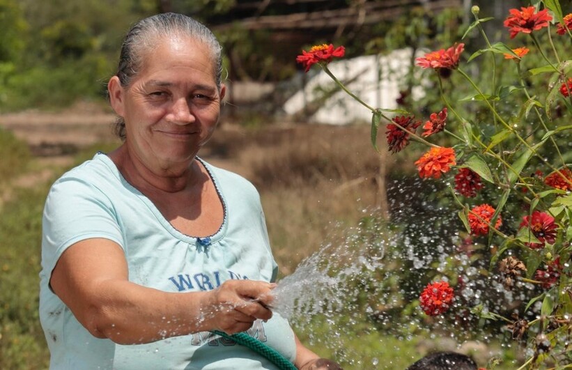 Woman watering plant (CRS Central America)