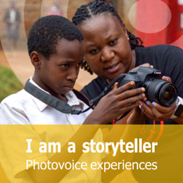Naomi Kabarungi and schoolboy looking at photo camera