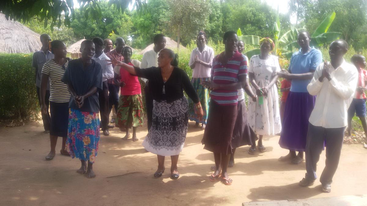 AC EHD Julian Kyomuhangi joins residents of Aton ODF village to welcome the GSF delegation with a traditional dance
