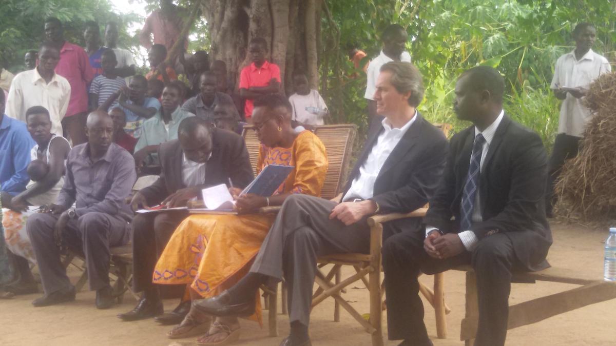 Minister of Health, Dr Jane Ruth Acheng signs the visitors' book at Aton ODF Village