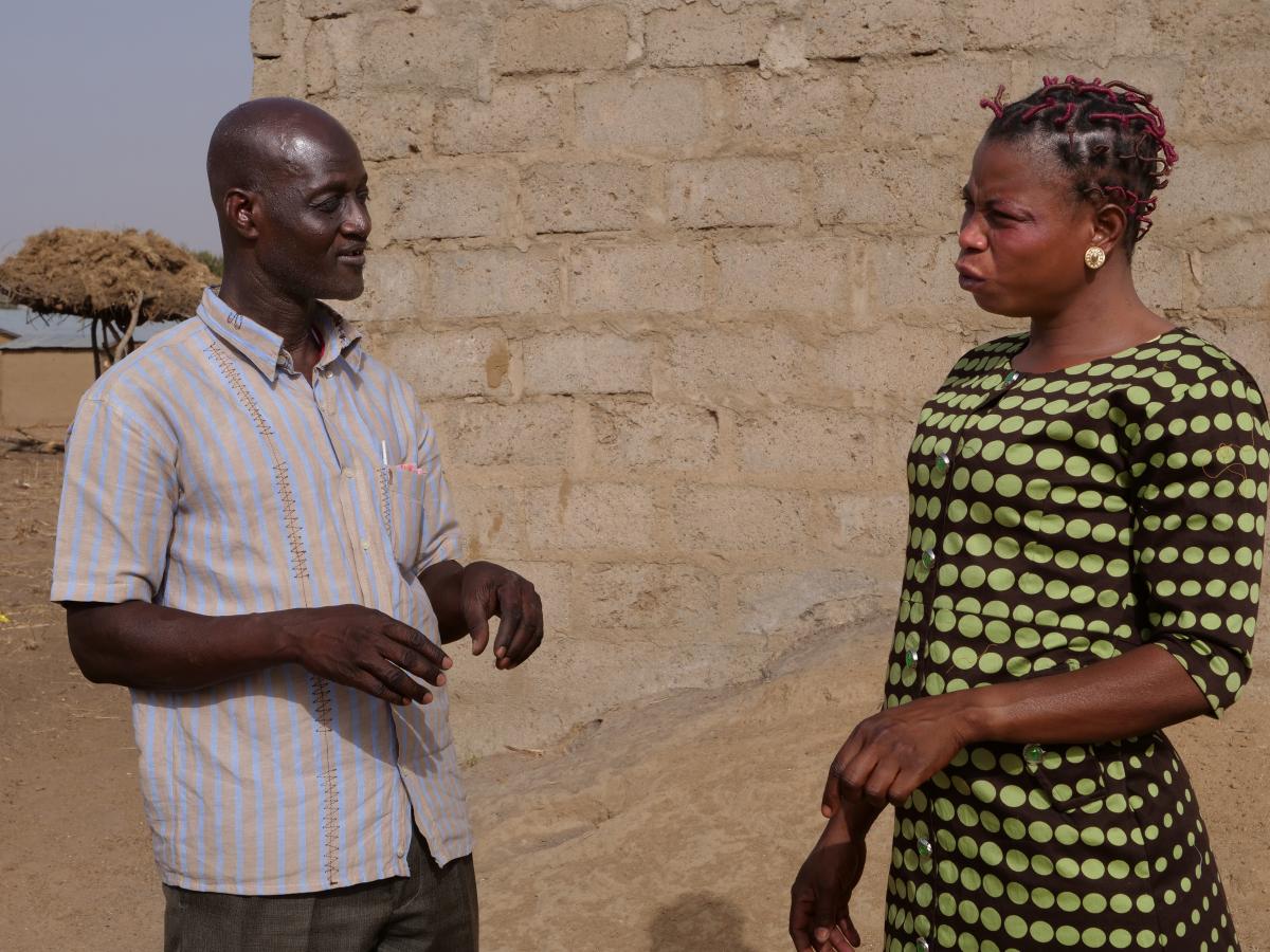 Bongo District Environmental Health Officer Mumuni Abdulai discusses sanitation with Jennifer Nyaaba, a member of the Asaloko Water and Sanitation Management Team Bongo District Environmental Health Officer Mumuni Abdulai discusses sanitation with Jennifer Nyaaba, a member of the Asaloko Water and Sanitation Management Team
