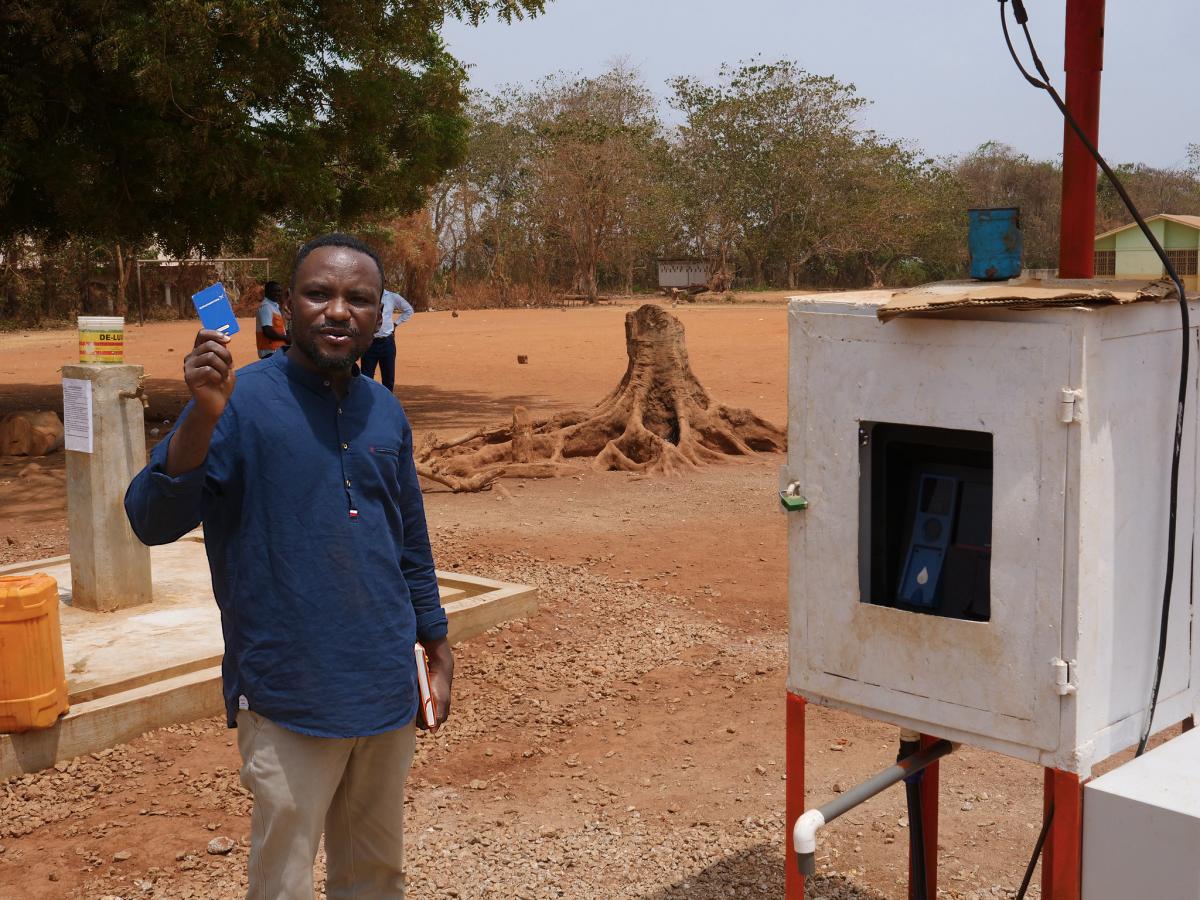 Festus Boadi at automated water point Festus Boadi at automated water point