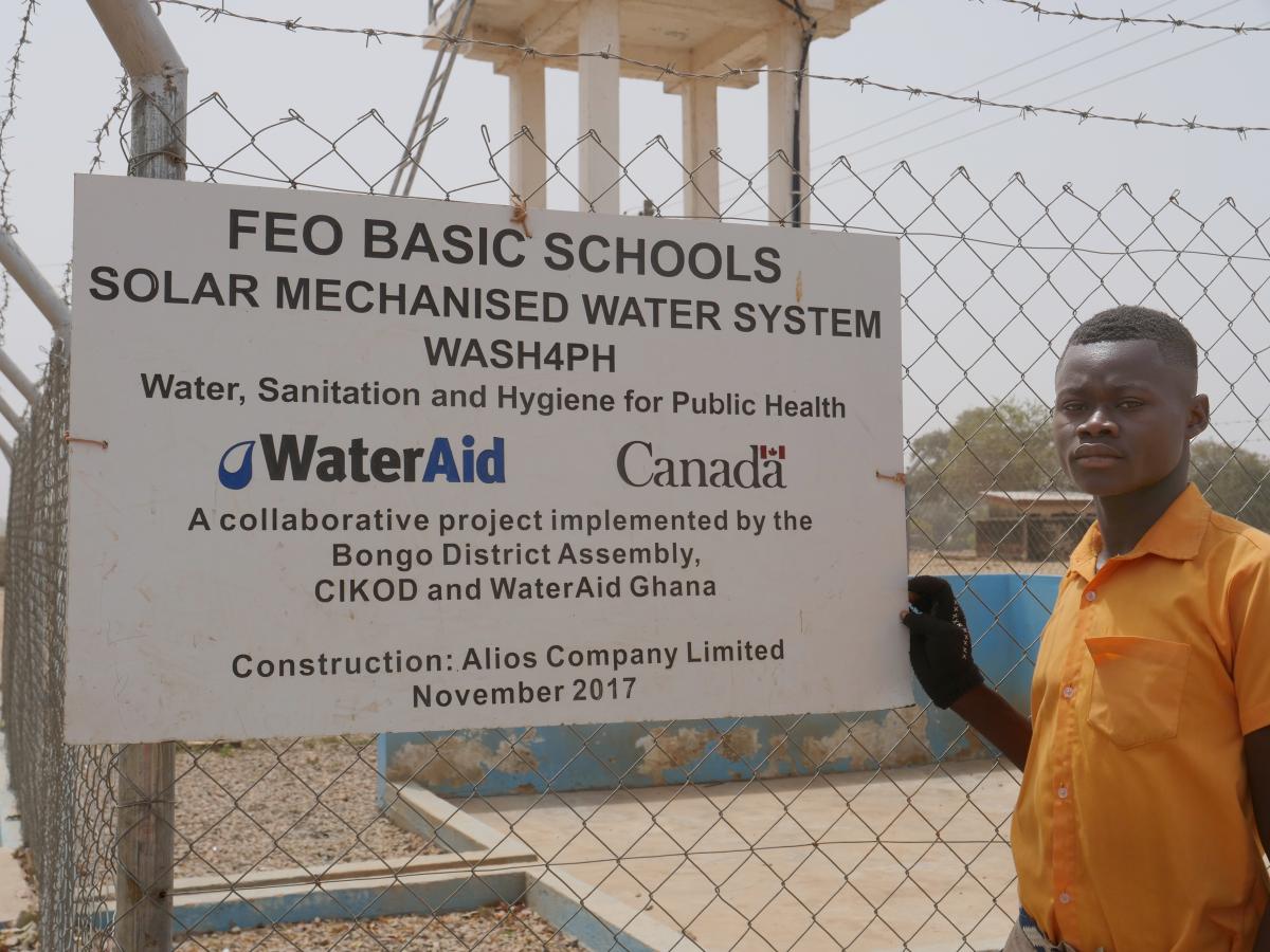 Phileman Azura, aged 15, a student at Foe Junior High School B at the solar mechanised water point installed by WaterAid Ghana and Bongo District Assembly supported by donor money from Canada Phileman Azura, aged 15, a student at Foe Junior High School B at the solar mechanised water point installed by WaterAid Ghana and Bongo District Assembly supported by donor money from Canada