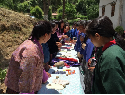 Students demonstrate how to make reuseable sanitary pads. Photo credtit: SNV Students demonstrate how to make reuseable sanitary pads