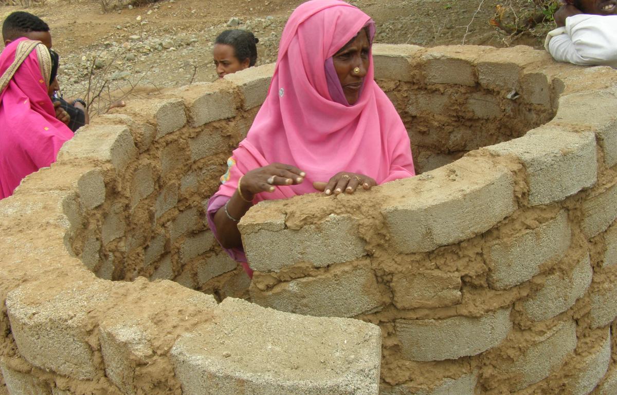 Woman constructing latrine in Wazinet village, Eritrea. Photo: Petra Brussee/IRC Woman constructing latrine in Wazinet village, Eritrea