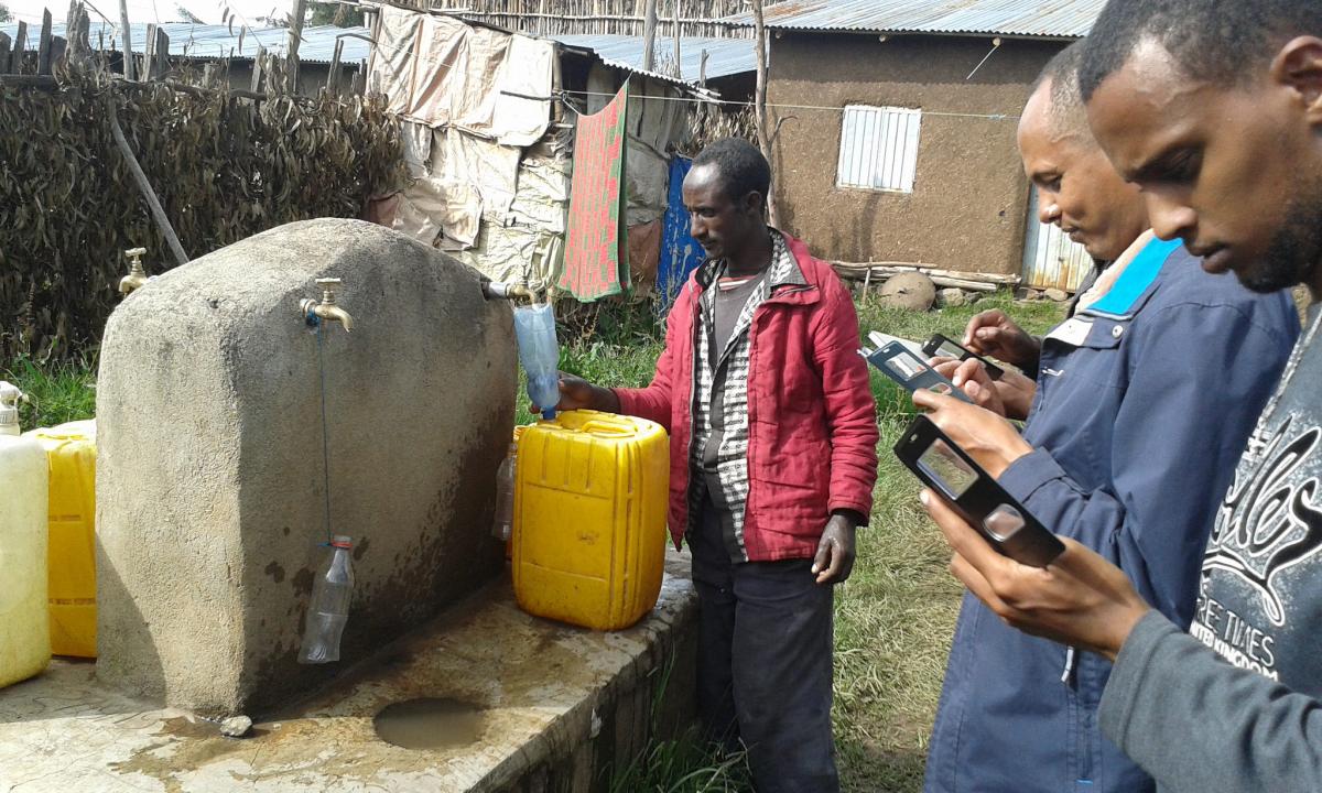 Collecting WASH baseline data in Ethiopia. Photo: IRC Collecting WASH baseline data with mobile phones at standpipe in Ethiopia