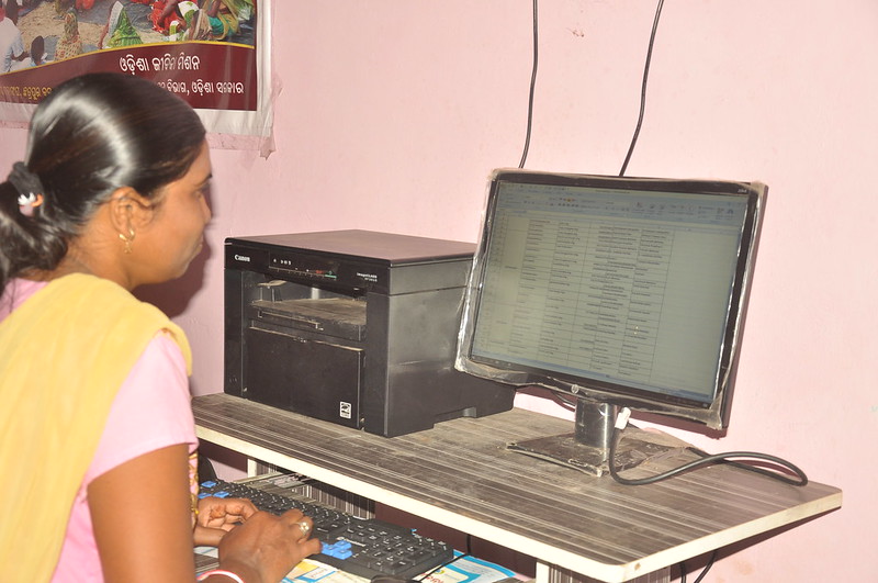 Ganjam district, Odisha, India Photo: IRC Woman sitting in front of computer screen in Ganjam district, Odisha, India