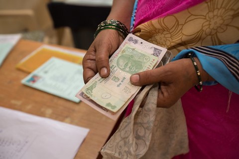 Women counting money - Water.org image