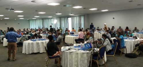 Various tables with participants at the National Learning Exchange