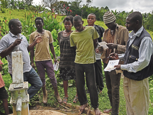 Martin Watsisi (left), talks to community members at Magura shallow well in Karambi sub-county, Kabarole District Martin Watsisi (left), talks to community members at Magura shallow well in Karambi sub-county