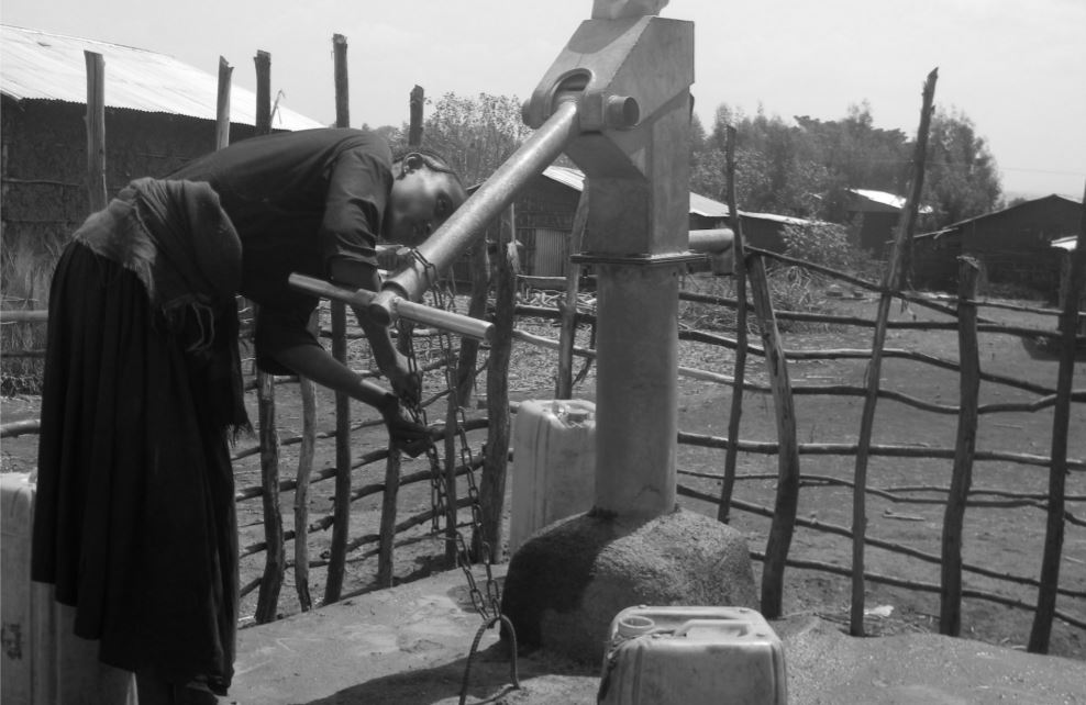 Women next to hand pump in Ethiopia Women next to hand pump in Ethiopia