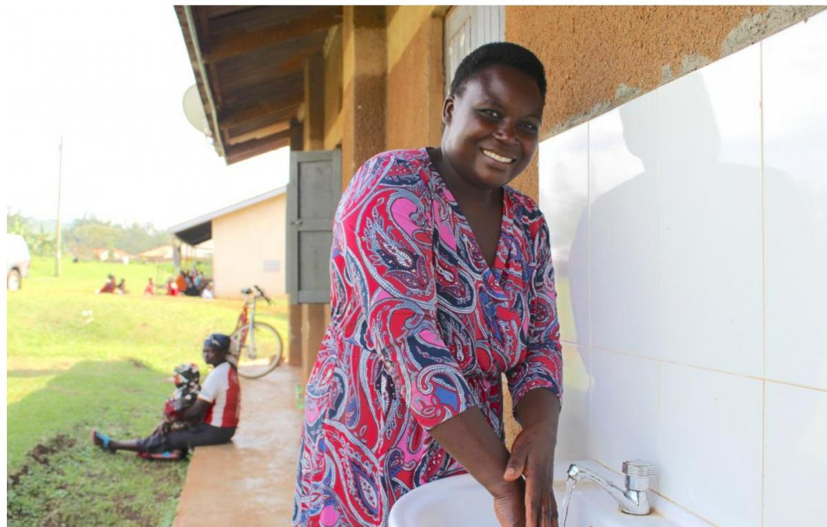 Cecilia using a water tap