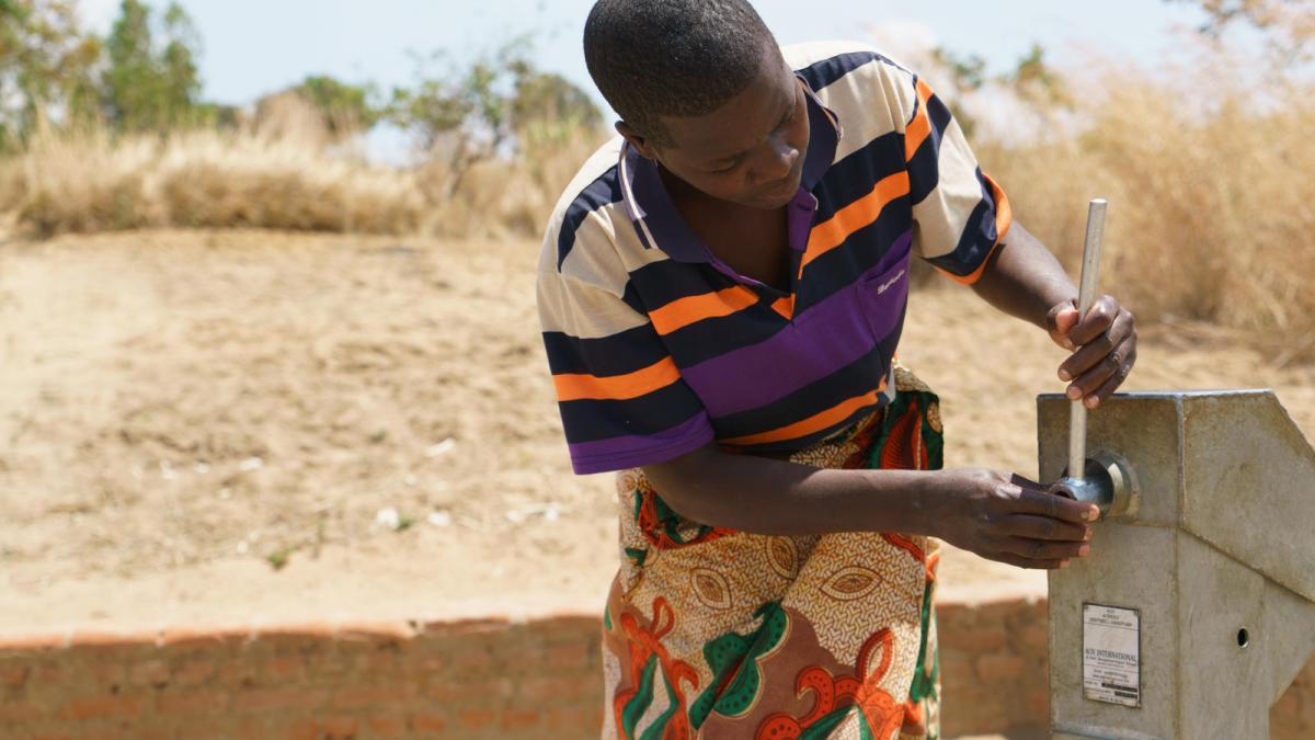 Man fixing handpump