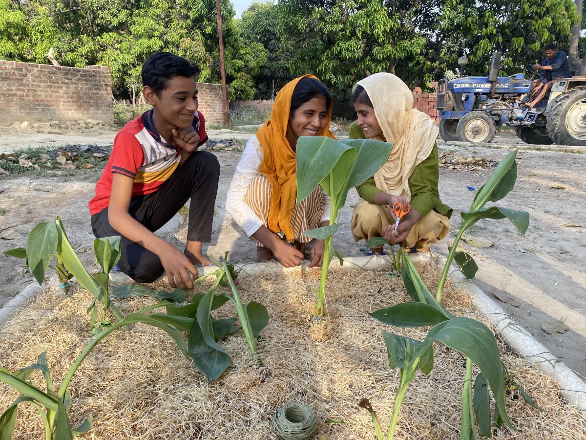 Young girls constructing a floating wetland